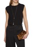 模特儿示范图 - 点击放大 - TOTEME - Mini T-lock Leather Clutch Bag